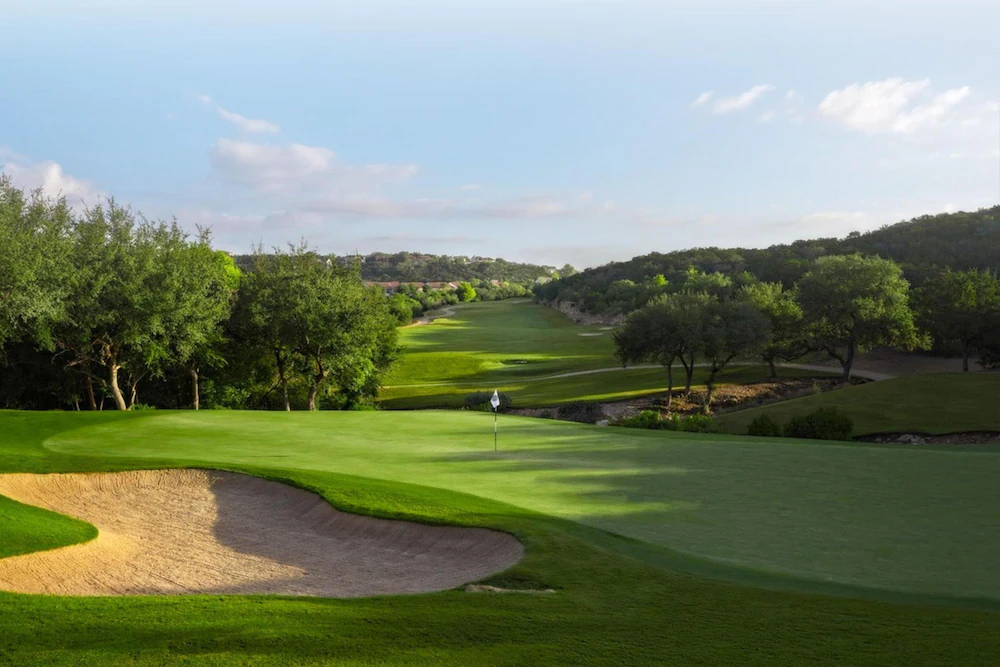Signature green with Hill Country backdrop